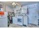 Functional laundry room with washer, dryer, storage cabinets, and ample space for sorting and folding clothes at 3048 Mango Tree Dr, Edgewater, FL 32141