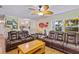 Inviting living area with leather sofas, ceiling fan, and ample space for entertaining guests at 3048 Mango Tree Dr, Edgewater, FL 32141