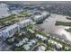 Expansive aerial view of waterfront condos, marina, and coastal landscape with boat docks at 306 Sheldon St, New Smyrna Beach, FL 32168