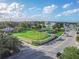 Aerial view of beautiful park with manicured lawn, historic ruins, and lush green trees under a blue sky at 306 Sheldon St, New Smyrna Beach, FL 32168