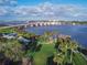 Scenic aerial view of a bridge over a river with waterfront park offering recreational amenities and lush greenery at 306 Sheldon St, New Smyrna Beach, FL 32168