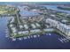 Breathtaking aerial view of waterfront condos and marina with boat docks in a scenic coastal community at 306 Sheldon St, New Smyrna Beach, FL 32168