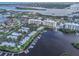 Aerial shot of waterfront community featuring condominiums, boat docks, and scenic water views under a sunny sky at 306 Sheldon St, New Smyrna Beach, FL 32168