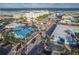 Aerial view of charming coastal community with vibrant blue buildings, palm trees, and oceanfront hotels at 306 Sheldon St, New Smyrna Beach, FL 32168
