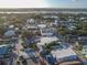 Panoramic aerial view of a charming coastal town with lush trees, streets, and distant bridge at 306 Sheldon St, New Smyrna Beach, FL 32168