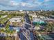 Aerial view of a quaint beach town featuring palm trees and colorful buildings by the sea at 306 Sheldon St, New Smyrna Beach, FL 32168