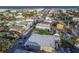 Aerial view of a lively coastal town featuring colorful buildings, streets, and proximity to the beach at 306 Sheldon St, New Smyrna Beach, FL 32168