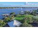 Scenic aerial view of a waterfront park with docks, covered seating, lush landscaping, and serene waterways at 306 Sheldon St, New Smyrna Beach, FL 32168