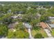 A residential area with tree-lined streets, manicured lawns, and homes with gray roofs at 3120 Mango Tree Dr, Edgewater, FL 32141