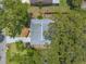A real estate overview showing lush landscaping and tree coverage with a view of the roof at 3120 Mango Tree Dr, Edgewater, FL 32141