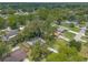 A bird's eye view reveals a residential neighborhood with mature trees and well-kept houses at 3120 Mango Tree Dr, Edgewater, FL 32141
