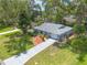 Charming single-story home with a well-maintained lawn, landscaped garden beds, and a paved driveway at 3120 Mango Tree Dr, Edgewater, FL 32141