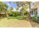 An idyllic backyard with a verdant lawn and mature trees creates a private and serene outdoor space at 3120 Mango Tree Dr, Edgewater, FL 32141