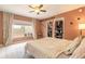 Comfortable bedroom with tile flooring, natural light, closet, and ceiling fan at 3120 Mango Tree Dr, Edgewater, FL 32141