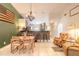 An open-concept dining area featuring tiled floors, modern lighting, and a charming accent wall at 3120 Mango Tree Dr, Edgewater, FL 32141