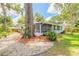 Home exterior with landscaped yard and a screened patio at 3120 Mango Tree Dr, Edgewater, FL 32141