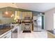 Efficient kitchen featuring stainless steel appliances, mosaic backsplash, and tile flooring at 3120 Mango Tree Dr, Edgewater, FL 32141