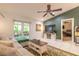 Cozy living room featuring tile flooring, large windows, and modern furnishings at 3120 Mango Tree Dr, Edgewater, FL 32141