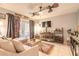 Well-decorated living room with tile floors, a ceiling fan, and sliding door access to the lanai at 3120 Mango Tree Dr, Edgewater, FL 32141