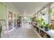 Bright sunroom with tiled floor and a greenhouse perfect for a plant enthusiast at 3120 Mango Tree Dr, Edgewater, FL 32141