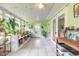 Light-filled sunroom featuring tiled floors and an array of potted plants at 3120 Mango Tree Dr, Edgewater, FL 32141