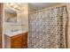 Bathroom featuring a wood vanity with marble top and a shower with a patterned curtain at 3222 Juniper Dr, Edgewater, FL 32141