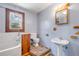 Bathroom featuring a tub shower, wood vanity, pedestal sink and window at 3222 Juniper Dr, Edgewater, FL 32141