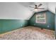 Green bedroom with a ceiling fan and window, offering a serene and comfortable space at 3222 Juniper Dr, Edgewater, FL 32141
