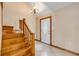 Entryway with wood stairs, a white door, and tiled flooring with an overhead light at 3222 Juniper Dr, Edgewater, FL 32141