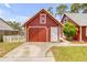 View of a red garage with white trim and a white star above the double garage doors at 3222 Juniper Dr, Edgewater, FL 32141