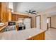 Practical kitchen featuring tile countertops, wood cabinets, and stainless appliances with access to other living areas at 3222 Juniper Dr, Edgewater, FL 32141