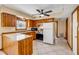 Well-lit kitchen with wooden cabinets, stainless appliances, tiled floors, and a convenient breakfast bar at 3222 Juniper Dr, Edgewater, FL 32141