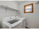 Laundry room features LG washing machine and dryer next to a window and shelving at 3222 Juniper Dr, Edgewater, FL 32141