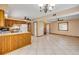 Bright living room showcasing an open floorplan with tiled floors, ceiling fans, and access to the kitchen at 3222 Juniper Dr, Edgewater, FL 32141