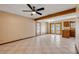 Open living space with tile floors, ceiling fan, and glass doors leading to the outside at 3222 Juniper Dr, Edgewater, FL 32141