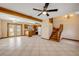 Open living area with tile floors, ceiling fan, and a view into the kitchen at 3222 Juniper Dr, Edgewater, FL 32141