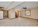 Spacious living area with tile flooring, fan, and an entryway visible in the distance at 3222 Juniper Dr, Edgewater, FL 32141