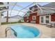 A kidney shaped pool is visible next to the house with seating and a white fence surrounding the backyard at 3222 Juniper Dr, Edgewater, FL 32141