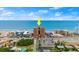 Aerial view of beachfront condo building and the beach with blue skies at 3245 S Atlantic Ave # 208, Daytona Beach, FL 32118