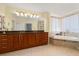Bathroom features a soaking tub, glass-enclosed shower, and double vanity at 3245 S Atlantic Ave # 208, Daytona Beach, FL 32118