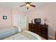 The bedroom includes tile flooring, twin beds, ceiling fan, and a dresser with a TV at 3245 S Atlantic Ave # 208, Daytona Beach, FL 32118