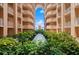Beautiful courtyard with tropical plants and an archway with sky view at 3245 S Atlantic Ave # 208, Daytona Beach, FL 32118