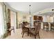 Cozy dining area adjacent to the kitchen, perfect for casual meals with wicker chairs and a glass table at 3245 S Atlantic Ave # 208, Daytona Beach, FL 32118