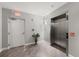 Hallway with tiled floor, elevator, exit sign and door in a condo building at 3245 S Atlantic Ave # 208, Daytona Beach, FL 32118
