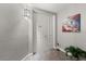 Entryway featuring a white door, neutral walls with decorations, and tile flooring at 3245 S Atlantic Ave # 208, Daytona Beach, FL 32118