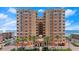 Beautiful exterior shot of a modern multi-story condo building near the ocean and beach at 3245 S Atlantic Ave # 208, Daytona Beach, FL 32118
