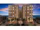 Condo exterior with palm trees, portico, circular driveway, and ocean view at 3245 S Atlantic Ave # 208, Daytona Beach, FL 32118