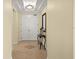 Bright hallway with decorative table, mirror and double-door closet at 3245 S Atlantic Ave # 208, Daytona Beach, FL 32118