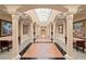 Grand hallway featuring architectural columns and tiled floors at 3245 S Atlantic Ave # 208, Daytona Beach, FL 32118