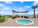 Inviting hot tub with brick pavers, ocean view, and shaded lounge area at 3245 S Atlantic Ave # 208, Daytona Beach, FL 32118
